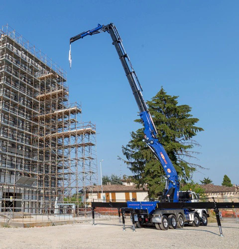 An all terrain crane with outriggers.